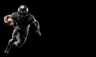 American football player in a black helmet and uniform runs with a ball in his right hand in the right part of the frame on a black background photo