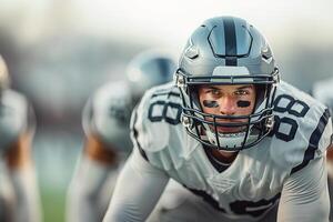 American football player in a gray helmet and white uniform stands waiting for the ball to be drawn. Copy space photo