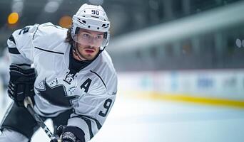 A hockey player in a black and white uniform at the hockey arena during a match on the left side of the frame. Copy space photo