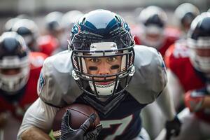 American football player runs with the ball in his right hand during a match. Against the background of the crowd, a crowd of players from the opposing team is running photo