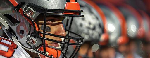 An American football player. A helmeted head in close-up profile. Copy space photo