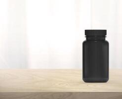 Black supplement bottle for medicine on wooden table photo