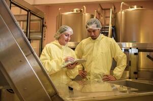 Professional winemaker controlling wine making process and quality at winery factory photo