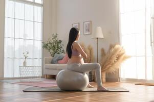 Healthy pregnant woman exercising and doing prenatal yoga, meditation, working out, yoga, pregnancy concept. photo