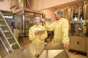 Professional winemaker controlling wine making process and quality at winery factory photo