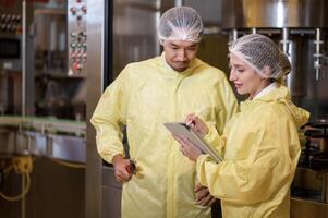 Professional winemaker controlling wine making process and quality at winery factory photo