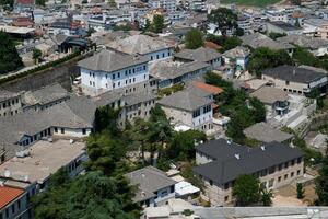 Fortress in Gjirokastra a huge stone building on a high mountain in Albania with a clock the history of the Middle Ages a beautiful view from the stone city to the ancient village photo