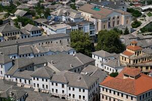 Fortress in Gjirokastra a huge stone building on a high mountain in Albania with a clock the history of the Middle Ages a beautiful view from the stone city to the ancient village photo