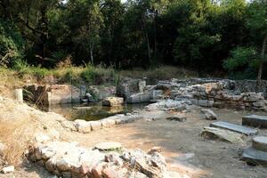 Ruins of the Great Basilica in Butrint National Park, Buthrotum, Albania. Triconch Palace at Butrint Life and death of an ancient Roman house Historical medieval Venetian Tower surrounded photo