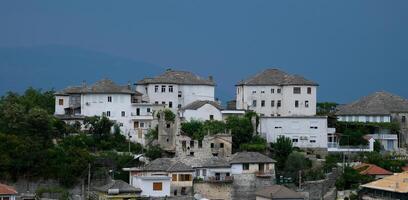 Fortress in Gjirokastra a huge stone building on a high mountain in Albania with a clock the history of the Middle Ages a beautiful view from the stone city to the ancient village photo
