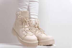 Light shoes women's boots with laces with high soles on a white background classic fashion show for purchase for winter autumn shoes store beige color milky color photo