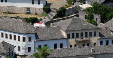 Fortress in Gjirokastra a huge stone building on a high mountain in Albania with a clock the history of the Middle Ages a beautiful view from the stone city to the ancient village photo