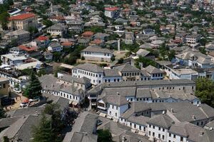 Fortress in Gjirokastra a huge stone building on a high mountain in Albania with a clock the history of the Middle Ages a beautiful view from the stone city to the ancient village photo