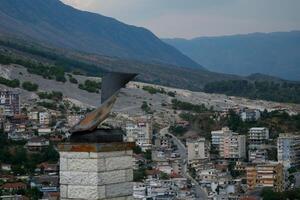 Fortress in Gjirokastra a huge stone building on a high mountain in Albania with a clock the history of the Middle Ages a beautiful view from the stone city to the ancient village photo
