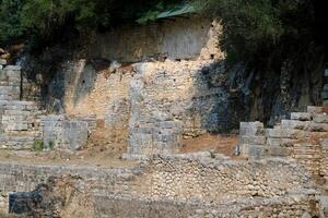 Ruins of the Great Basilica in Butrint National Park, Buthrotum, Albania. Triconch Palace at Butrint Life and death of an ancient Roman house Historical medieval Venetian Tower surrounded photo