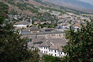 Fortress in Gjirokastra a huge stone building on a high mountain in Albania with a clock the history of the Middle Ages a beautiful view from the stone city to the ancient village photo