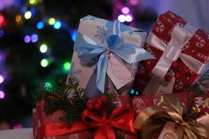 colorful Christmas gift boxes on floor near fir tree photo