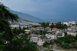 Fortress in Gjirokastra a huge stone building on a high mountain in Albania with a clock the history of the Middle Ages a beautiful view from the stone city to the ancient village photo