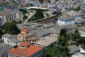 Fortress in Gjirokastra a huge stone building on a high mountain in Albania with a clock the history of the Middle Ages a beautiful view from the stone city to the ancient village photo
