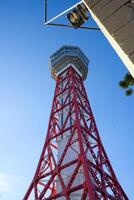 View of Hakata Port Tower, a red lattice metal observation tower in the Hakata district of Fukuoka, Japan photo
