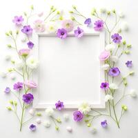 Beautiful decorated purple pink soft flowers on white background with blank photo frame. Sweet mockup blossom bouquet in spring by