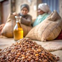 Heap of Moroccan Argan nut seeds for oil extract manufacturing in Morocco, used for cosmetic skin hair care and healthy culinary purpose. photo