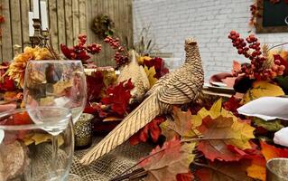 Wooden huge Table massive on which there are devices on wooden stands Mystical mysterious Halloween crows and other golden birds sit on the table Autumn bright orange and yellow flowers dry up photo