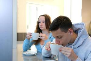 beautiful couple enjoying a cup of tea coffee at a luxurious villa during the summer talking smiling laughing and having a great time photo