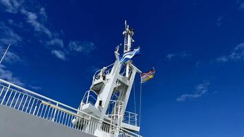 The upper deck of the ferry departing from Canada to Vancouver Island is a clean white deck with a blue flag white stripes on a blue background This is the flag of the ferry everywhere sea-ocean photo