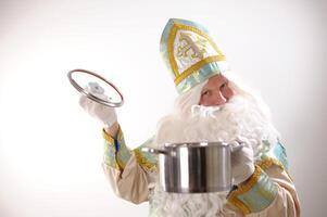 different positive emotions of St. Nicholas the Wonderworker who was founder of Santa Claus St. Nicholas is popularly called he is dressed in turquoise suit with gold with traditional religious cap photo