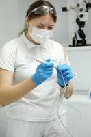 saline gloves dentistry The nurse collects the saline solution of sodium chloride from the bottle into the syringe. Antibiotic breeding, vaccination, prevention and treatment of diseases photo