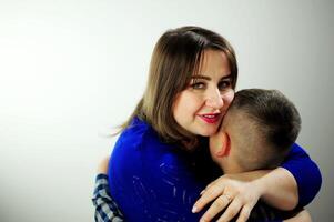 people tenderness relationship emotions Sad child hugging his mother Mom in a blue package tenderly hugs the prices who returned it under her arm and leaned very gently hugs love family comfort photo