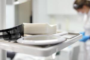 mirror napkins sunglasses on the background of the dental chair man blurred selective focus dental treatment stomatology photo