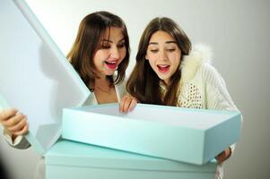 Online delivery empty boxes emotions facial expression greetings and gifts Mom and daughter look into box are surprised have fun and rejoice Woman aged 40 girl 16-18 positive emotions beautiful people photo