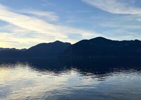 Porteau Cove Provincial Park Sunset city immersed in water reflecting in the Pacific Ocean creating mirror image camera moves slowly capturing the beauty of nature Background for travel travel agency photo