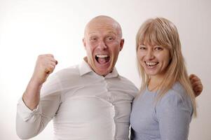 Loud sincere laughter man and woman in blue looking at the camera They open their mouths wide and laugh then look at each other and talk slow motion adults 50-55 Joy happiness success funny comedy photo