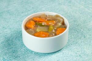 chinese mixed vegetables with capsicum, tomato, carrot, and radish served in bowl isolated on sky background closeup side view of bangladeshi food photo