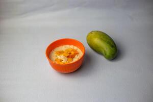 Doi Chira muri with mango served in bowl isolated on grey background side view of bangladeshi food photo