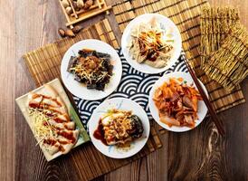 assorted taiwan side dishes Duck rice blood, Pork liver, pig scalp, Garlic white meat, Preserved egg tofu, with chopsticks served in dish isolated on napkin top view on table taiwan food photo