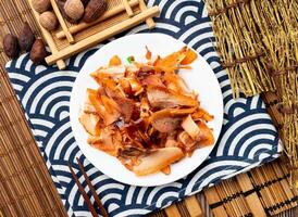 pig scalp with chopsticks served in dish isolated on napkin top view on table taiwan food photo