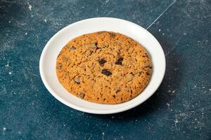 Chocolate Chips Cookies served in plate isolated on background side view of cafe baked food photo