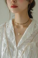 Woman Wearing White Shirt and Necklace photo