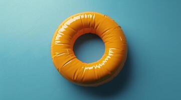 Orange Inflatable Pool Ring Floating in Water on Sunny Day photo