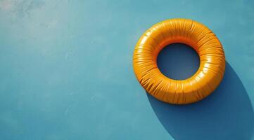 Orange Inflatable Pool Ring Floating in Water on Sunny Day photo