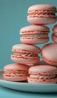 Plate of Pink Macaroons on Blue Table photo
