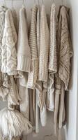 Array of Sweaters Hanging on Wall photo