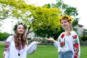 product advertisement of a natural remedy for the skin ukrainian young girls hold palms on which you can write a text about the place for advertising photo