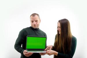 Two software developers analyzing source code looking at green screen chroma key mockup with coworker sitting at desk writing algorithm. Software developers working on artificial intelligence project. photo