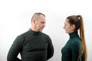 Photo of attractive confident sister brother wear green sweater hands crossed looking each other isolated grey color background