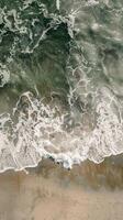 Aerial View of Ocean Waves and Sand photo